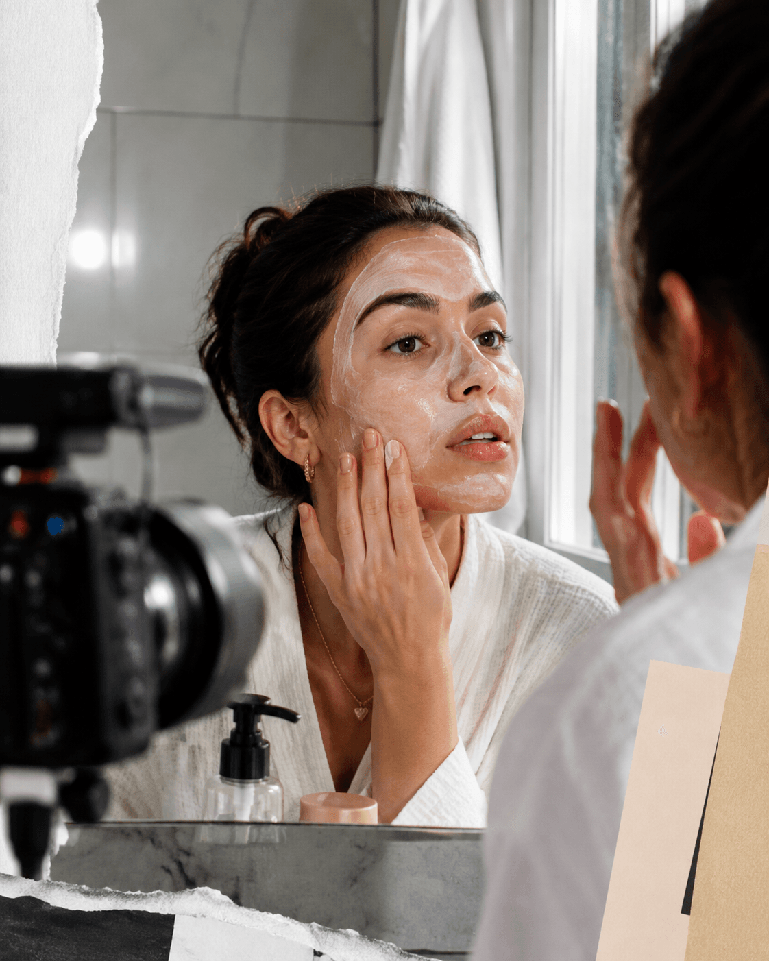 Temporary behind-the-scenes production image: a woman applying skincare at a mirror while a camera records